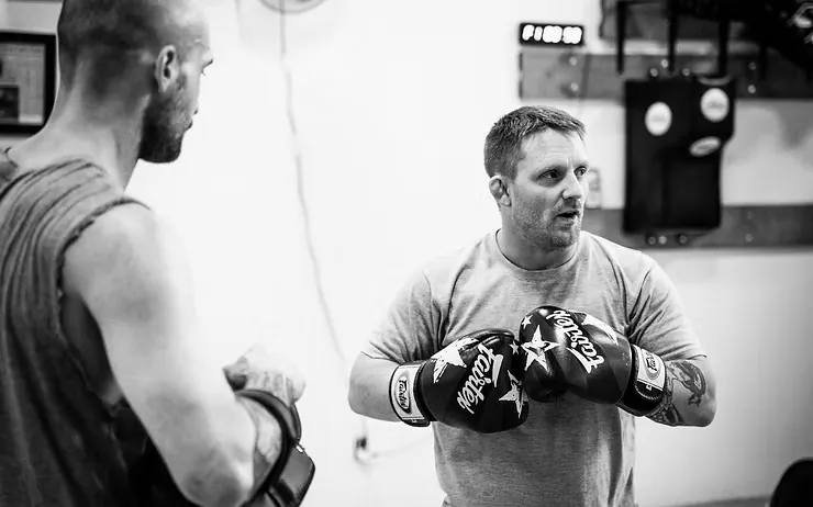 Muay Thai coach giving instruction between rounds at Mission BJJ in Mission, BC
